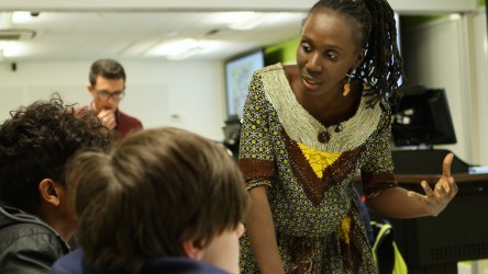 Educator in discussion with two pupils